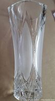 Full view of the clear lead crystal flower vase showing oval cut pattern and beveled top edge.