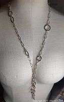Front view of the silver chain necklace displayed on a mannequin torso showing its length and link pattern