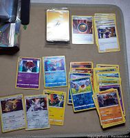 Photo showing a spread of Pokémon cards including foil cards, basic and evolved Pokémon of various types, 5 Trainers including 'Avery', and Energy cards.