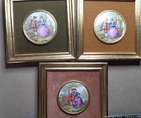 Photo showing all three miniature porcelain cameo art pieces framed on colored velvet backgrounds.