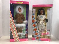 Both Inuit Barbie and Native American Barbie dolls displayed in original packaging, showing front view of boxed dolls.