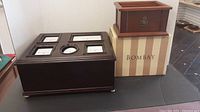 The two boxes displayed with the original Bombay striped box visible under the smaller box, showing size comparison and overall condition.