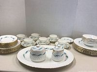 Image showing complete set including plates, cups, sugar bowl, and gravy boat arranged on table