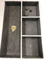 Overview of tray showing all necklaces, pendants, rings, and earring