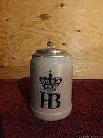 Front view of the vintage Hofbrauhaus Munchen HB beer stein showing the crown and HB logo on the ceramic body.