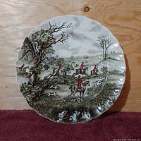 Front view of the vintage Johnson Bros Tally Ho THE JUMP dinner plate showing detailed hunting scene, scalloped edges.