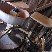 Side angle showing electric potter's wheel, work table, and seat.