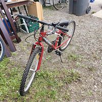 Red Supercycle SC1800 mountain bike angled view showing tires, handlebars, and frame.