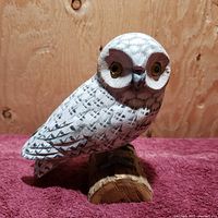 Front and slightly side view of the carved white owl figure showcasing detailed painted feathers and base