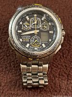 Front view of the Citizen Eco-Drive Skyhawk men's watch showing the dial, hands, subdials, digital displays, and titanium bracelet.