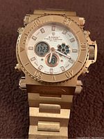 Front face and bracelet of the Men's S-Force watch in gold tone showing analog and digital displays, bezel markings, and multiple side buttons.