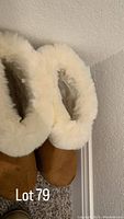 Front and top view of brown booties with white fur trim around the opening, size 9 showing very lightly worn condition.