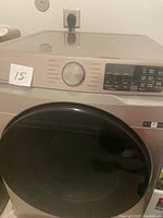 Front view of front load dryer showing control panel with cycle options and Wi-Fi feature