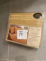 Photo of packaged king size 4 piece Egyptian cotton sheet set in beige color, brand Elegant Comfort with premium hotel quality, 1500 thread count and other features.