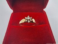 Front view of the ring showing the 10K gold band and diamond cluster in a floral/star pattern on top.