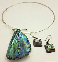 Full view of the abalone silver necklace with the matching earrings shown side by side.
