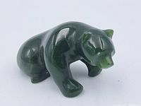 Front side view of the polished jade bear figure showing crouching posture and form detail.