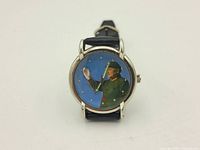 Front view of the wristwatch showing the dial with Mao Zedong in military uniform, silver-tone case, and black leather strap.