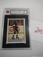Front view of the Wayne Gretzky 1989-90 OPC sticker in KSA 9 Mint graded holder showing player in black and white uniform on ice with Gulf Oil ad in background.