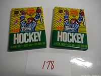 Two unopened 1990 Topps Hockey wax packs, front view showing the colorful packaging and text.