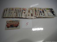 Wide array of hockey cards laid out, showing front view and a team card of Detroit Red Wings.