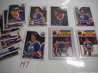 Photo showing 10 vintage 1985 OPC Edmonton Oilers hockey cards featuring players like Lee Fogolin, Mark Messier, Paul Coffey, and Jari Kurri.