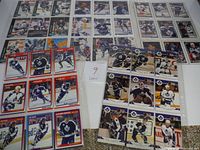 Spread of vintage Toronto Maple Leafs hockey cards in plastic sleeves showing players and goalies in various action and profile shots.