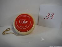 Front face of the Coca-Cola yo-yo showing the red label with 'Drink Coke', 'Galaxy 200', and promotional text.