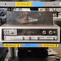 Front view of the Fleetwood 1T 9565 stereo system with dust cover down, showing control panel and tuning dial.