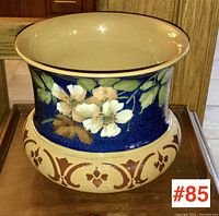 Full view of antique Langley Ware pottery jardiniere showing floral decoration and tan base with ornamental band.