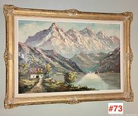 Full frontal view of the framed signed landscape painting with mountain and lake scene.