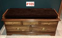 Front view of the cedar chest bench showing cushion and drawers with brass handles.