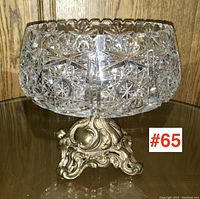 Front angled view of crystal pedestal bowl showing detailed cut patterns and ornate metal base