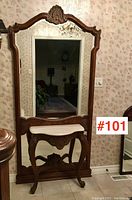 Full front view of oak hallstand showing carved frame, mirror, and marble shelf