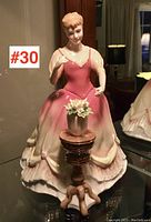 Front view of Royal Doulton figurine "Sarah" HN3380 in pink gown with small flower pedestal table.