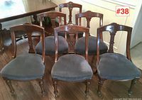 Full view of set of six antique Jacques & Hayes dining chairs with carved backs and grey upholstered seats.