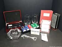 Full lot shot showing all 10 items including wooden box with wine accessories, two glasses, poker chips, two card games, ashtray and metal stir rods, bottle opener.