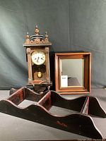 Front view showing clock, mirror and shelf grouping