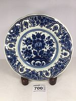Front view of the Blauw Delfts decorative plate showing detailed blue floral pattern on white background with scalloped edge.
