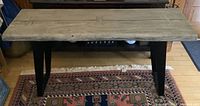 Full front view of console table showing live-edge acacia wood top and angled iron legs