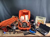 Wide shot showing full lot including Skilsaw saw in case, Black and Decker router, Wilton vise, Sears router box, hand brace, chisels, screwdrivers and hand plane