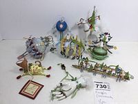 Photo showing eight large Krinkles ornaments including a white hand, musical dog, birds, and other whimsical designs.