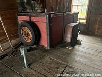 Side view showing wooden panels, metal frame and front hitch jack