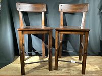 Pair of stools front view on wooden platform