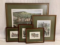 Photo shows full lot of 5 framed colored etchings with green mats depicting scenes of Germany in various sizes, arranged against white background.