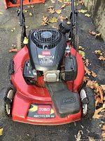 Front view of red Toro Recycler 22 lawn mower showing the deck, engine cover with Toro branding, and front wheel drive feature.