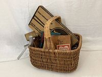 Basket filled with assorted kitchen items including cookbooks and utensils