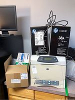 HP LaserJet 4200 printer with two HP toner cartridges and Panasonic film cartridge on top and adjacent.