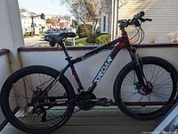 Side view of the left side of the SIRDAR S-700 mountain bike showing frame, saddle, and tires