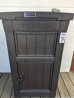 Front view of brown package delivery safety box with embossed packages text and delivery instruction on lid.